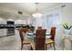 Bright dining area with a glass table, seating for four, and natural light from a window at 12212 N Paradise Village S Pkwy # 444, Phoenix, AZ 85032