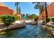 Exterior view of the community with a pool, desert landscaping, and mature trees on a clear, sunny day at 12212 N Paradise Village S Pkwy # 444, Phoenix, AZ 85032