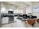 Modern kitchen featuring stainless steel appliances, white cabinets, and sleek black countertops at 12212 N Paradise Village S Pkwy # 444, Phoenix, AZ 85032
