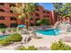 Community pool and spa with waterfalls, mature desert landscaping, mature trees, and lounge seating at 12212 N Paradise Village S Pkwy # 444, Phoenix, AZ 85032