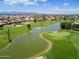 Expansive aerial view of a lush green golf course, lake and beautiful community at 12939 W Prospect Dr, Sun City West, AZ 85375