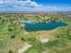 Aerial view of the community showing the golf course and lake with a mountain backdrop at 12939 W Prospect Dr, Sun City West, AZ 85375