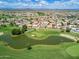 Scenic aerial of a green golf course and lake surrounded by a residential community at 12939 W Prospect Dr, Sun City West, AZ 85375