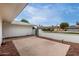 Backyard featuring a concrete patio area, landscaping, and views of the surrounding neighborhood at 12939 W Prospect Dr, Sun City West, AZ 85375