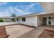 Backyard featuring a concrete patio area, landscaping, and views of the surrounding neighborhood at 12939 W Prospect Dr, Sun City West, AZ 85375