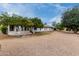 Expansive backyard featuring mature trees, an enclosed patio, and drought-resistant landscaping at 12939 W Prospect Dr, Sun City West, AZ 85375