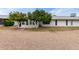 Rear exterior view featuring mature shade trees, low maintenance desert landscaping and sun room addition at 12939 W Prospect Dr, Sun City West, AZ 85375