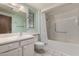Well-lit bathroom featuring a large mirror, vanity, toilet, and shower-tub combo at 12939 W Prospect Dr, Sun City West, AZ 85375