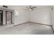 Open bedroom space showing bathroom entrance, ceiling fan, and carpeted flooring at 12939 W Prospect Dr, Sun City West, AZ 85375