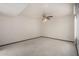 Neutral carpeted bedroom featuring a ceiling fan and ample natural light at 12939 W Prospect Dr, Sun City West, AZ 85375