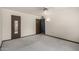 Spacious bedroom with neutral carpeting and two entryways, bathed in sunlight at 12939 W Prospect Dr, Sun City West, AZ 85375