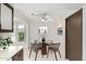 Cozy dining area with a round table, four chairs, and natural light from a window at 12939 W Prospect Dr, Sun City West, AZ 85375