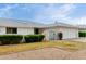 Charming single-story home with a two-car garage, manicured bushes, and small decorative entry gate at 12939 W Prospect Dr, Sun City West, AZ 85375