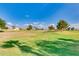 Beautifully maintained golf course with vibrant green grass and mature trees under a sunny sky at 12939 W Prospect Dr, Sun City West, AZ 85375