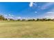 Scenic view of the lush green golf course with mature trees on a sunny day at 12939 W Prospect Dr, Sun City West, AZ 85375