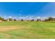 Expansive view of the community golf course with clear blue skies and scattered clouds at 12939 W Prospect Dr, Sun City West, AZ 85375
