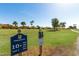 Beautiful golf course view with course signage, lush green grass, and well-maintained landscaping at 12939 W Prospect Dr, Sun City West, AZ 85375