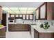 Well-lit kitchen with wood cabinets, white countertops, and a white tile floor at 12939 W Prospect Dr, Sun City West, AZ 85375