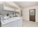 Well-lit laundry room with washer, dryer, and storage shelves for convenience and organization at 12939 W Prospect Dr, Sun City West, AZ 85375