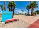 Lawn Bowl park area featuring benches and mature palm trees on a sunny day at 12939 W Prospect Dr, Sun City West, AZ 85375