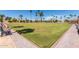 Well-maintained lawn bowling green surrounded by paved walkways and comfortable seating at 12939 W Prospect Dr, Sun City West, AZ 85375