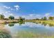 Scenic pond reflecting a blue sky on a golf course at 12939 W Prospect Dr, Sun City West, AZ 85375