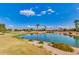 Scenic view of a golf course pond, reflecting blue sky and trees at 12939 W Prospect Dr, Sun City West, AZ 85375