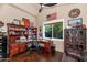 Bright home office with wood furnishings, a window, and decor for a comfortable and productive workspace at 13896 E Kalil Dr, Scottsdale, AZ 85259