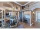 Kitchen featuring a dining area, arched doorways, and a custom built-in desk at 13896 E Kalil Dr, Scottsdale, AZ 85259