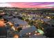 Night aerial view showcasing an illuminated community with a large backyard oasis at 16044 N 106Th Way, Scottsdale, AZ 85255