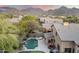 Aerial view showcases a stunning backyard oasis with pool, putting green, and lush landscaping at 16044 N 106Th Way, Scottsdale, AZ 85255