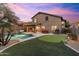 Beautiful backyard featuring a sparkling pool, putting green, patio, and lush landscaping at 16044 N 106Th Way, Scottsdale, AZ 85255