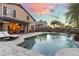 Beautiful backyard pool area with travertine pavers and lush landscaping at 16044 N 106Th Way, Scottsdale, AZ 85255