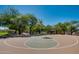 Well-maintained basketball court surrounded by mature trees, perfect for friendly games and exercise at 16044 N 106Th Way, Scottsdale, AZ 85255