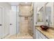 Bathroom featuring a glass-enclosed shower with seat, stone accents, and granite countertop at 16044 N 106Th Way, Scottsdale, AZ 85255