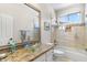 Stylish bathroom featuring a glass vessel sink, granite countertops, and tiled shower/tub combo at 16044 N 106Th Way, Scottsdale, AZ 85255
