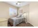 Well-lit bedroom showcasing a ceiling fan, plantation shutters, modern lamp, and comfortable decor at 16044 N 106Th Way, Scottsdale, AZ 85255