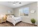 Cozy bedroom featuring a ceiling fan, bright window, plush bed, and attractive decor at 16044 N 106Th Way, Scottsdale, AZ 85255