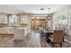 Dining room with backyard pool views and modern light fixture, located right off the kitchen at 16044 N 106Th Way, Scottsdale, AZ 85255