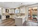 Modern kitchen with white cabinets, stainless steel appliances, a quartz countertop island, and access to the backyard pool at 16044 N 106Th Way, Scottsdale, AZ 85255