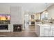 Open-concept kitchen with fireplace, breakfast bar, and modern appliances at 16044 N 106Th Way, Scottsdale, AZ 85255