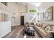 Spacious living room with vaulted ceilings, hardwood floors, and fireplace at 16044 N 106Th Way, Scottsdale, AZ 85255
