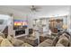 Spacious living room with fireplace and mounted TV open to the kitchen, dining and backyard at 16044 N 106Th Way, Scottsdale, AZ 85255