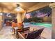 Inviting covered patio with stylish seating, a ceiling fan, and views of the pool and backyard at 16044 N 106Th Way, Scottsdale, AZ 85255