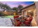 Charming outdoor patio featuring comfortable seating, a dining table, and a view of the pool at 16044 N 106Th Way, Scottsdale, AZ 85255