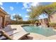 Inviting backyard pool with a waterfall feature, lounge chairs, and well-maintained landscaping at 16044 N 106Th Way, Scottsdale, AZ 85255