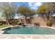 Sparkling pool with a waterfall feature surrounded by lush landscaping and a paved patio at 16044 N 106Th Way, Scottsdale, AZ 85255