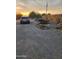 Open gravel driveway and outdoor work area with a parked car at 1618 S Cedar Dr, Apache Junction, AZ 85120