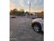 Spacious gravel driveway with plenty of parking and partial view of chain link fence and car at 1618 S Cedar Dr, Apache Junction, AZ 85120
