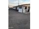 Exterior view of the white and brown residential building with a gravel yard at 1618 S Cedar Dr, Apache Junction, AZ 85120